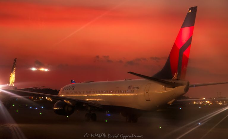 Delta Air Lines, Delta, Boeing 737, Boeing, N831DN, sunset, landing, lights, jet, taxiing, aircraft, airplane, plane, airport, Atlanta Airport, fly, fight, travel, lighting, pink, purple, orange, red, sky, colorful, dreamy, surreal, flares, light flares, air travel, airline, aviation, commercial jet, DAL, DAL stock, Hartsfield-Jackson Atlanta International Airport, Atlanta, ATL, KATL, BA, BA stock, runway, weather, Georgia, aerial, aerial view, aerial photography, aerial photographer, David Oppenheimer, color, horizontal, United States, 1-13439195601,