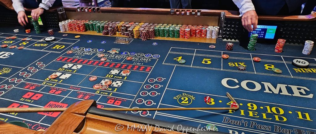 Craps table gambling at The Venetian casino in Las Vegas, Nevada - © 2025 David Oppenheimer - Performance Impressions travel photography archives - https://performanceimpressions.com The Venetian, casino, Las Vegas, craps, craps table, dice, chips, casino chips, money, roll of the dice, roll the dice, dice game, roll, table, gaming, play, Nevada, odds, win, gambling, wager, bet, luck, gamble, resort, 3355 S Las Vegas Blvd, 89109, United States, horizontal, color, 1-14977862771