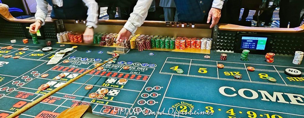 Craps table gambling at The Venetian casino in Las Vegas, Nevada - © 2025 David Oppenheimer - Performance Impressions travel photography archives - https://performanceimpressions.com The Venetian, casino, Las Vegas, craps, craps table, dice, chips, casino chips, money, roll of the dice, roll the dice, dice game, roll, table, gaming, play, Nevada, odds, win, gambling, wager, bet, luck, gamble, resort, 3355 S Las Vegas Blvd, 89109, United States, horizontal, color, 1-14977862771
