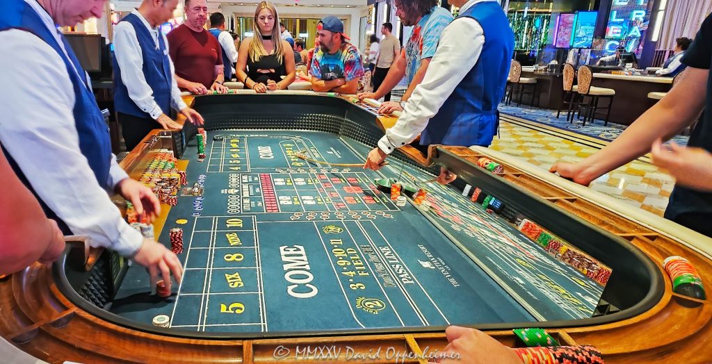 Craps table gambling at The Venetian casino in Las Vegas, Nevada - © 2025 David Oppenheimer - Performance Impressions travel photography archives - https://performanceimpressions.com The Venetian, casino, Las Vegas, craps, craps table, dice, chips, casino chips, money, roll of the dice, roll the dice, dice game, roll, table, gaming, play, Nevada, odds, win, gambling, wager, bet, luck, gamble, resort, 3355 S Las Vegas Blvd, 89109, United States, horizontal, color, 1-14977862771