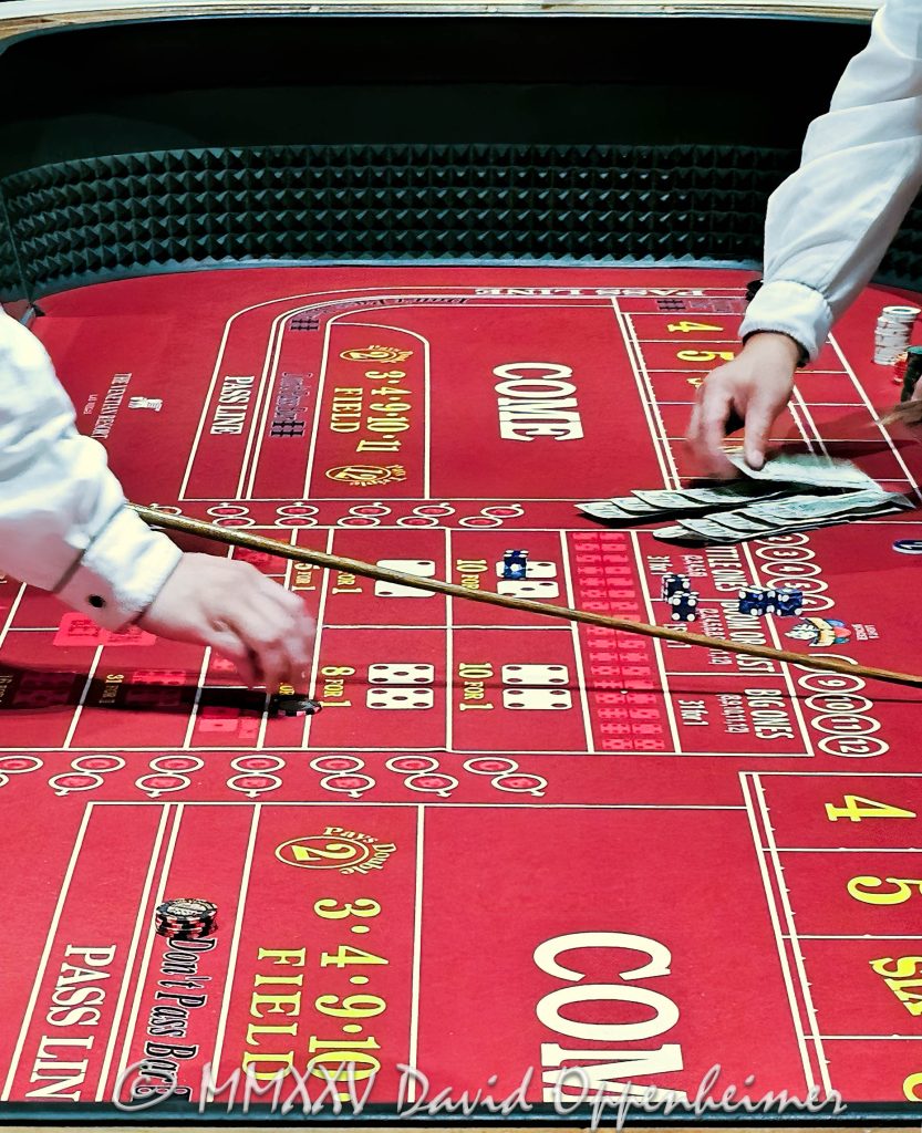 Craps table gambling at The Venetian casino in Las Vegas, Nevada - © 2025 David Oppenheimer - Performance Impressions travel photography archives - https://performanceimpressions.com The Venetian, casino, Las Vegas, craps, craps table, dice, chips, casino chips, money, roll of the dice, roll the dice, dice game, roll, table, gaming, play, Nevada, odds, win, gambling, wager, bet, luck, gamble, resort, 3355 S Las Vegas Blvd, 89109, United States, vertical, color, 1-14977862771