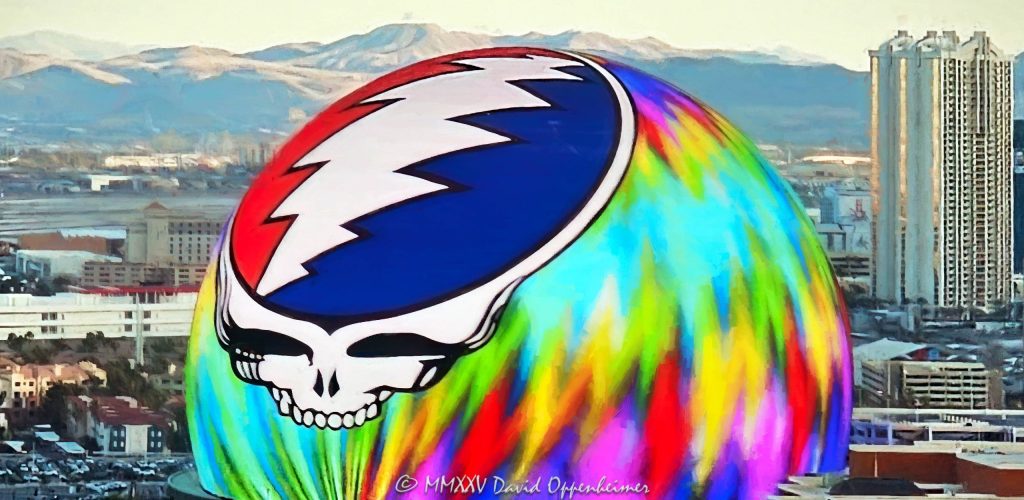 Daytime photograph of Sphere in Las Vegas featuring the illuminated Steal Your Face logo during Dead & Company’s 2024 residency. Despite bright daylight conditions, the vibrant LED display is clearly visible in this aerial view thanks to professional camera exposure and optics - © 2025 David Oppenheimer - Performance Impressions aerial photography archives - https://performanceimpressions.com Sphere, Sphere in Las Vegas, Las Vegas Sphere, MGM Sphere, Sphere at The Venetian, Las Vegas, Steal Your Face, Dead & Company, Grateful Dead, residency, daytime, LED display, facade, building, outside, lights, lighting, 255 Sands Ave, 89169, round, spherical, Sphere Entertainment, Sphere Entertainment Group, Paradise, marketing, advertising, entertainment, media, screen, display, MSG Networks, MSG, Nevada, entrance, architecture, facility, venue, art, artwork, painting, United States, horizontal, color, 1-14977862771