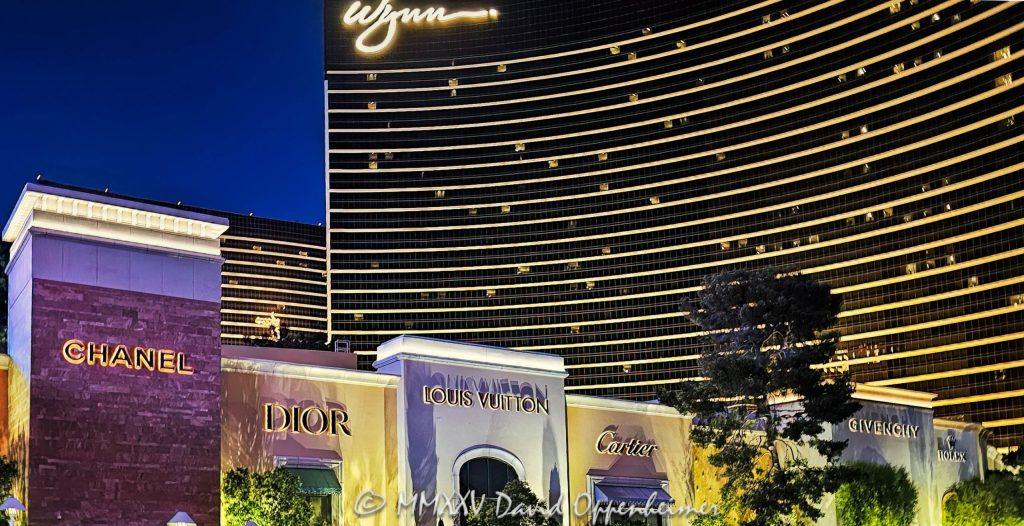 The Shops at Wynn and Encore Wynn Plaza Shops luxury boutiques CHANEL, Dior, Louis Vuitton, Cartier, GIVENCHY, and Rolex at Wynn and Encore Las Vegas resort and casino in Las Vegas, Nevada - © 2025 David Oppenheimer - Performance Impressions photography archives - https://performanceimpressions.com The Shops, The Shops at Wynn and Encore, Wynn, Encore, Encore Las Vegas, Encore Resort, Encore Casino, Encore Vegas, Encore at Wynn, Wynn Las Vegas, Wynn Vegas, plaza shops, plaza, Wynn Plaza Shops, Wynn Resort, Wynn Casino, Wynn Resorts, 3131 Las Vegas Blvd S, 89109, hotel, casino, brands, luxury brands, resort, building, architecture, shops, shopping, bridge, night, lights, city lights, boutiques, stores, storefront, sign, signage, WYNN, WYNN stock, five star, luxury, Louis Vuitton, CHANEL, Dior, Cartier, Rolex, GIVENCHY, Fashion Show Mall Bridge to Wynn, Fashion Show Mall Bridge, Las Vegas, Vegas, Las Vegas at night, Las Vegas city lights, Las Vegas Strip, Las Vegas Strip architecture, Las Vegas night photography, night photo, nighttime, cityscape, urban photography, mall, Fashion Show, vacation, escape, dream, art, fine art, artwork, painting, resort architecture, casino lights, neon lights, modern architecture, urban, casinos, facade, urban design, design, skyline, Nevada, Nevada photography, colorful, United States, horizontal, color, 1-14977862771