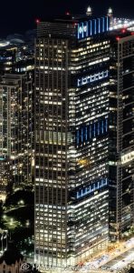 Blue Cross Blue Shield Tower at 300 East Randolph in downtown Chicago, Illinois, located near Millennium Park and Grant Park in the Loop business district. Contemporary commercial skyscraper architecture featuring illuminated office floors, architectural lighting, reflective glass facade design, and dramatic nighttime exterior visibility. The headquarters tower for Health Care Service Corporation was originally designed by Lohan Associates and later vertically expanded by Goettsch Partners. - © 2026 David Oppenheimer - Performance Impressions photography archives https://performanceimpressions.com 300 East Randolph, 300 E Randolph, 300 East Randolph Street, East Randolph Street, Blue Cross Blue Shield Tower, BCBS Tower, Blue Cross Blue Shield Building, Health Care Service Corporation, HCSC, Chicago, Chicago Illinois, Illinois, United States, 60601, Downtown Chicago, Chicago Loop, Millennium Park, Grant Park, architecture, Chicago architecture, architectural photography, urban architecture, modern architecture, contemporary architecture, skyscraper, office tower, high-rise, building, tower, office building, commercial building, corporate tower, corporate headquarters, commercial real estate, corporate real estate, real estate, business district, financial district, commercial architecture, corporate architecture, downtown, urban, glass tower, glass building, glass facade, reflective glass, illuminated building, illuminated windows, office lights, building lights, architectural lighting, nighttime architecture, night photography, night scene, evening light, illuminated facade, lighting design, exterior lighting, reflections, iconic building, American architecture, Illinois architecture, exterior, waterfront, office headquarters, Chicago skyscraper, Chicago office tower, downtown office tower, office architecture, Lohan Associates, Goettsch Partners, Magnusson Klemencic Associates, Blue Cross Blue Shield of Illinois, vertical expansion, commercial photography, commercial imagery, image licensing, licensing, photography licensing, vertical, David Oppenheimer, 1-15156784411