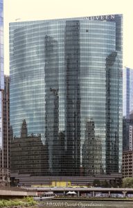 333 Wacker Drive curves along the Chicago River in the Loop, with its blue-green glass facade reflecting the riverfront and Chicago Riverwalk below. Designed by Kohn Pedersen Fox, the postmodern office tower is a widely recognized Wacker Drive skyscraper and a Chicago address associated with Nuveen – © 2026 David Oppenheimer – Performance Impressions photography archives https://performanceimpressions.com 333 Wacker Drive, 333 West Wacker Drive, 333 W Wacker Drive, 333 W Wacker Dr, 333 West Wacker, 333 W Wacker, 333 Wacker, 333 Wacker Drive Chicago, 333 West Wacker Chicago, Nuveen 333 Wacker Drive, Nuveen Chicago, Nuveen Investments, Nuveen Asset Management, Nuveen LLC, TIAA, TIAA company, Chicago Loop, Loop Chicago, downtown Chicago, Chicago Illinois, Chicago IL, West Wacker Drive, Wacker Drive, Chicago River, Chicago Riverwalk, Riverwalk Chicago, Chicago riverfront, riverfront, Loop riverfront, Franklin Street, Lake Street, 60606, facade, building exterior, exterior, glass facade, curved glass facade, blue green glass, green glass facade, reflective glass, glass reflection, reflection, river reflection, Chicago River reflection, mirrored facade, office tower, office building, commercial building, Class A office building, skyscraper, high rise, tower, architecture, architectural photography, Chicago architecture, downtown Chicago architecture, riverfront architecture, postmodern architecture, contextual architecture, commercial architecture, Kohn Pedersen Fox, KPF, Kohn Pedersen Fox Associates, William Pedersen, HKS, Hines, Beacon Capital Partners, Nuveen sign, corporate tenant, asset management, investment management, financial services, Ferris Bueller building, Chicago skyline, Illinois architecture, United States, Licensing, image licensing, commercial imagery, photography licensing, art, print, fine art, commercial photography, David Oppenheimer, vertical, 1-15156784411