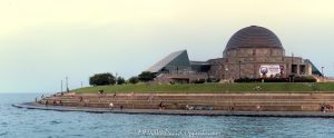 Adler Planetarium and Skyline Walk line Chicago’s Lake Michigan waterfront as people enjoy a summer afternoon along the curved shoreline, with the Art Deco planetarium and glass Sky Pavilion overlooking the water. Located at 1300 South DuSable Lake Shore Drive, the complex combines Ernest A. Grunsfeld Jr.’s original 1930 planetarium with the later pavilion by Lohan Associates – © 2026 David Oppenheimer – Performance Impressions photography archives https://performanceimpressions.com Adler Planetarium and Skyline Walk, Adler Planetarium Skyline Walk, Adler Planetarium, Adler Planetarium Chicago, Skyline Walk, Skyline Walk Chicago, Adler Skyline Walk, Adler Planetarium and Astronomy Museum, 1300 S DuSable Lake Shore Drive, 1300 South DuSable Lake Shore Drive, 1300 S Lake Shore Drive, 1300 South Lake Shore Drive, DuSable Lake Shore Drive, Lake Shore Drive, Museum Campus, Museum Campus Chicago, Northerly Island, Northerly Island Chicago, Northerly Island Park, Solidarity Drive, Near South Side, South Loop, South Loop Chicago, Chicago Illinois, Chicago IL, 60605, Lake Michigan, lake, water, lakefront, waterfront, shoreline, seawall, seawall seating, waterfront seating, lakefront seating, benches, outdoor benches, promenade, walkway, walking path, Lakefront Trail, Chicago Lakefront Trail, people, visitors, tourists, sightseeing, sitting, walking, recreation, outdoors, public space, Chicago lakefront, Chicago waterfront, Lake Michigan waterfront, planetarium, museum, astronomy museum, science museum, space museum, astronomy, science, space, education, attraction, Chicago attraction, tourist attraction, cultural attraction, Chicago museum, first planetarium, historic planetarium, facade, building exterior, exterior, museum exterior, Art Deco, Art Deco facade, granite facade, rainbow granite, copper dome, dome, historic facade, 12 sided building, Sky Pavilion, glass pavilion, curved glass, Doane Observatory, observatory, historic building, landmark building, National Historic Landmark, architecture, architectural photography, Chicago architecture, museum architecture, Art Deco architecture, historic architecture, Ernest A Grunsfeld Jr, Ernest Grunsfeld, Max Adler, Alfonso Iannelli, Lohan Associates, Chicago Park District, Illinois architecture, United States, licensing, image licensing, commercial imagery, photography licensing, art, print, fine art, commercial photography, David Oppenheimer, horizontal, 1-15213827141