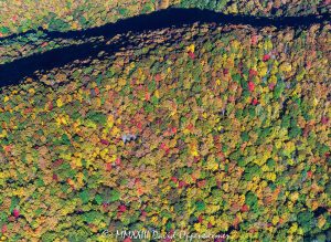 Autumn Colors below a Shadowed Ridgeline of the Blue Ridge Parkway in Haywood County, North Carolina Aerial View