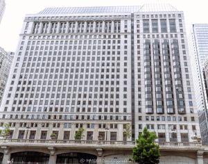 Builders Building at 222 North LaSalle Street in Chicago, Illinois, located along the Chicago River in the Loop business district. Historic commercial office architecture designed by Graham, Anderson, Probst & White featuring a classical stone facade, riverfront positioning, and modernized office space within the West Loop–LaSalle Street Historic District. Built in 1927 and later expanded and renovated by Skidmore, Owings & Merrill, the building is also known as 222 North LaSalle – © 2026 David Oppenheimer – Performance Impressions photography archives https://performanceimpressions.com Builders Building, Builders BLDG, 222 North LaSalle, 222 North LaSalle Street, 222 N LaSalle, 222 N LaSalle Street, North LaSalle Street, LaSalle Street, Chicago, Chicago Illinois, Illinois, United States, 60601, Downtown Chicago, Chicago Loop, Chicago River, Chicago riverfront, Chicago Riverwalk, architecture, Chicago architecture, architectural photography, facade, building exterior, exterior, historic architecture, classical architecture, neoclassical architecture, Beaux-Arts architecture, commercial architecture, office architecture, office tower, office building, commercial building, building, tower, high-rise, stone facade, limestone facade, classical facade, historic facade, riverfront architecture, riverfront building, riverfront office building, commercial real estate, corporate real estate, real estate, business district, financial district, corporate architecture, downtown, urban, historic building, historic district, West Loop-LaSalle Street Historic District, American architecture, Illinois architecture, daylight, waterfront, financial center, business center, Class A office building, Chicago office tower, downtown office tower, Graham Anderson Probst White, Graham Anderson Probst and White, GAPW, Skidmore Owings Merrill, Skidmore Owings and Merrill, SOM, Tishman Speyer, Turner Construction, commercial photography, commercial imagery, image licensing, licensing, photography licensing, David Oppenheimer, horizontal, 1-15156784411