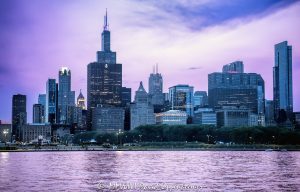 Chicago’s South Loop skyline rises beyond Grant Park at blue hour, with Buckingham Fountain and Queen’s Landing visible along the Lake Michigan waterfront beneath a violet evening sky. The lake reflects the fading post-sunset light as downtown office, residential, hotel, and cultural towers extend across the horizon in Chicago, Illinois – © 2026 David Oppenheimer – Performance Impressions photography archives https://performanceimpressions.com Chicago skyline, Chicago cityscape, Grant Park skyline, Chicago blue hour, Lake Michigan, Buckingham Fountain, Clarence Buckingham Fountain, Clarence F Buckingham Memorial Fountain, Queen’s Landing, Queens Landing, Grant Park, Chicago lakefront, Chicago waterfront, South Loop skyline, downtown Chicago, Chicago Loop, Loop Chicago, South Loop, West Loop, Financial District, Michigan Avenue, South Michigan Avenue, Chicago, Chicago Illinois, Chicago IL, Illinois, 60601, 60603, 60604, 60605, skyline, cityscape, landscape, urban landscape, blue hour, twilight, dusk, after sunset, evening, evening light, purple sky, violet sky, lake reflection, reflections, clouds, cloudscape, horizon, lake, water, lakefront, waterfront, shoreline, architecture, buildings, skyscrapers, towers, high rise, office towers, residential towers, hotel towers, real estate, Chicago real estate, South Loop real estate, commercial real estate, office real estate, residential real estate, Roosevelt University Wabash Building, Wabash Building, Roosevelt University, 425 S Wabash Ave, 425 South Financial Place, One Financial Place, Four40, 440 S LaSalle St, Chicago Stock Exchange, Peoples Gas Building, Peoples Gas Light and Coke Building, 122 S Michigan Ave, Metropolitan Tower, Straus Building, Britannica Building, Beehive Building, 310 S Michigan Ave, Symphony Center, Orchestra Hall, Chicago Symphony Orchestra, 220 S Michigan Ave, Railway Exchange Building, Santa Fe Building, Motorola Building, Motorola, Motorola Solutions, 224 S Michigan Ave, Chapin and Gore Building, 63 E Adams St, MacLean Center, Illinois Athletic Club, SAIC, 112 S Michigan Ave, Palmer House a Hilton Hotel, Palmer House Hilton, Hilton, 17 E Monroe St, Citadel Center, Dearborn Center, 131 S Dearborn St, The Franklin, Franklin Center, AT&T Corporate Center, 227 W Monroe St, Chicago Board of Trade Building, CBOT Building, 141 W Jackson Blvd, The Legacy at Millennium Park, Legacy Tower, 60 E Monroe St, Daniel Burnham, Skidmore Owings Merrill, SOM, Graham Anderson Probst White, Ricardo Bofill, Solomon Cordwell Buenz, Chicago skyline art, Chicago cityscape art, Chicago art, skyline photography, cityscape photography, landscape photography, architectural photography, urban photography, artwork, wall art, art print, Chicago print, skyline print, United States, licensing, image licensing, commercial imagery, photography licensing, art, print, fine art, commercial photography, David Oppenheimer, horizontal, 1-15213827141