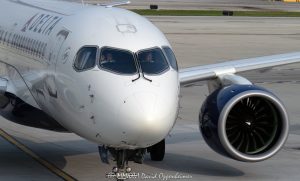 Delta Air Lines Airbus A220 Pilots at O’Hare International Airport Delta Air Lines Airbus A220 at Chicago O’Hare International Airport, shown from the front as two pilots remain focused in the cockpit while the jet taxis near the terminal ramp. The horizontal aviation scene shows the aircraft nose, diagonal cockpit windshields, Delta livery, and part of a wing-mounted engine in Chicago, Illinois – © 2026 David Oppenheimer – Performance Impressions photography archives https://performanceimpressions.com Delta Air Lines Airbus A220, Delta Airbus A220, Delta A220, Airbus A220, A220, Delta Air Lines, Delta Airlines, Delta jet, Delta aircraft, Delta plane, Delta livery, Delta Air Lines livery, Delta pilot, Delta pilots, pilots, pilot, piloting, cockpit, flight deck, cockpit crew, flight crew, airline pilots, aviation crew, focused pilots, pilot concentration, aircraft cockpit, cockpit windshields, diagonal windshields, slanted windshields, aircraft nose, jet nose, front of plane, nose section, wing-mounted engine, jet engine, turbofan engine, taxiing aircraft, taxiing jet, airport ramp, airport apron, terminal ramp, jetway, gate approach, airline operations, ground operations, airport operations, commercial aviation, passenger jet, commercial jet, narrowbody jet, narrow-body aircraft, airliner, aircraft, airplane, jet, aviation, air travel, transportation, travel, business travel, airport, Chicago O’Hare International Airport, O’Hare International Airport, Chicago O’Hare Airport, O’Hare Airport, Chicago O’Hare, ORD, KORD, 10000 W O’Hare Avenue, O’Hare, Chicago, Chicago Illinois, Chicago IL, Illinois, 60666, SkyTeam, SkyTeam airline, SkyTeam Alliance, DAL, DAL stock, Delta stock, NYSE DAL, Delta Air Lines Inc, airline stock, airline industry, travel industry, transportation industry, corporate aviation, airport photography, aviation photography, aircraft photography, airline photography, commercial photography, editorial photography, United States, licensing, image licensing, commercial imagery, photography licensing, art, print, fine art, commercial photography, David Oppenheimer, horizontal, 1-15213827141