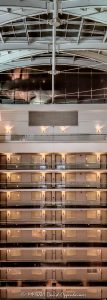 Embassy Suites by Hilton Chicago Downtown Magnificent Mile Upper Atrium Embassy Suites by Hilton Chicago Downtown Magnificent Mile atrium interior in Chicago, Illinois, showing approximately eight upper levels of stacked guestroom corridors across the vast open interior, with strong horizontal and vertical lines rising to the curved steel framing and glazed roof structure above – © 2026 David Oppenheimer – Performance Impressions photography archives https://performanceimpressions.com Embassy Suites by Hilton Chicago Downtown Magnificent Mile, Embassy Suites Chicago Downtown Magnificent Mile, Embassy Suites Chicago Magnificent Mile, Embassy Suites Magnificent Mile, Embassy Suites Chicago, Embassy Suites by Hilton, Embassy Suites, Embassy Suites atrium, Embassy Suites interior, Chicago Embassy Suites, 511 North Columbus Drive, 511 N Columbus Drive, 511 N Columbus Dr, 60611, hotel atrium, atrium interior, Chicago hotel atrium, Chicago hotel interior, hotel interior, atrium architecture, interior architecture, hotel architecture, open atrium, multi-story atrium, tall atrium, soaring atrium, glass atrium, atrium roof, vaulted atrium, vaulted roof, glass roof, metal roof, roof structure, roof framing, roof glazing, skylight, skylight roof, steel framing, structural steel, steel beams, steel girders, arched beams, steel arches, curved steel, curved beams, roof girders, tension rods, structural rods, support cables, structural cables, horizontal lines, vertical lines, linear geometry, architectural geometry, geometric architecture, repeating lines, repetition, architectural pattern, guest corridors, guestroom corridors, hotel corridors, interior corridors, open corridors, atrium corridors, upper floors, hotel floors, guestroom doors, interior walkways, structural engineering, engineering, architectural engineering, structural design, building structure, steel structure, hospitality architecture, hospitality design, interior design, commercial interior, commercial architecture, high-rise hotel, hotel tower, all-suite hotel, all suite hotel, upscale hotel, full service hotel, Chicago hotel, downtown Chicago hotel, Streeterville hotel, Magnificent Mile hotel, Chicago hospitality, Streeterville, River East, River East Chicago, River East Center, Magnificent Mile, downtown Chicago, Near North Side, Chicago, Chicago Illinois, Illinois, United States, USA, Embassy Suites Chicago Downtown-Lakefront, Embassy Suites Downtown Lakefront, Chicago Downtown Lakefront, DeStefano + Partners, DeStefano and Partners, DeStefano Partners, Greg Randall, architect, architecture firm, The Gettys Group, Gettys Group, Gettys, interior designer, MCL Companies, MCL, developer, Hilton, Hilton Worldwide, Hilton Worldwide Holdings, HLT, NYSE HLT, Hilton stock, Host Hotels & Resorts, Host Hotels, Host Hotels and Resorts, HST, NASDAQ HST, hotel REIT, hospitality, hotel, atrium, interior, architecture, structure, steel, glass, glazing, Art Deco, Art Deco influence, contemporary design, architectural photography, interior photography, hotel photography, Chicago architecture photography, structural photography, fine art photography, architectural print, photographic print, archival print, gallery print, collector print, wall art, Chicago architecture art, licensing, image licensing, commercial imagery, photography licensing, art, print, fine art, commercial photography, David Oppenheimer, David Oppenheimer photography, Performance Impressions, Performance Impressions photography archives, vertical, 1-15213827141