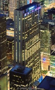 Chase Tower and Exelon Plaza Chicago City Lights Aerial View Chase Tower and Exelon Plaza night aerial photo in Chicago, Illinois, showing the 60-story office tower at 21 South Clark Street in the Loop financial district. Elevated nighttime view of the curved skyscraper, illuminated office floors, plaza area, city streets, and downtown commercial architecture near Clark, Dearborn, Madison, and Monroe Streets – © 2026 David Oppenheimer – Performance Impressions aerial photography archives https://performanceimpressions.com Chase Tower, Chase Tower Chicago, Exelon Plaza, Chase Tower Plaza, First National Plaza, First National Bank Building, Bank One Plaza, 21 South Clark, 21 South Clark Street, 21 S Clark, South Clark Street, Clark Street, Chicago, Chicago Illinois, Illinois, United States, 60603, Downtown Chicago, Chicago Loop, Loop, financial district, architecture, Chicago architecture, architectural photography, facade, building exterior, exterior, aerial, aerial photo, aerial photography, aerial photographer, aerial view, aerial image, night aerial, nighttime aerial, night photography, night photo, city lights, building lights, illuminated building, illuminated windows, office lights, nighttime architecture, skyscraper, high-rise, office tower, building, tower, office building, commercial building, corporate tower, corporate headquarters, commercial real estate, corporate real estate, real estate, business district, downtown, urban, curved tower, curved skyscraper, modern architecture, commercial architecture, corporate architecture, office architecture, concrete tower, reinforced concrete, plaza, public plaza, urban plaza, Chagall Four Seasons, Four Seasons mosaic, Marc Chagall, JPMorgan Chase, JP Morgan Chase, Exelon, First National Bank of Chicago, Bank One, C.F. Murphy Associates, CF Murphy Associates, Perkins and Will, Perkins+Will, commercial photography, commercial imagery, image licensing, licensing, photography licensing, art, print, fine art, David Oppenheimer, vertical, 1-15156784411