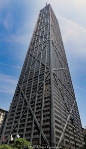 John Hancock Center at 875 North Michigan Avenue in Chicago 875 North Michigan Avenue, formerly the John Hancock Center, rises above the Magnificent Mile in Chicago, Illinois, with a tapered black facade defined by exposed steel X-bracing. Designed by Skidmore, Owings & Merrill through the collaboration of architect Bruce Graham and structural engineer Fazlur Rahman Khan, the mixed-use tower expresses its wind-resisting diagonalized tube directly on the exterior – © 2026 David Oppenheimer – Performance Impressions photography archives https://performanceimpressions.com John Hancock Center, John Hancock Center Chicago, 875 North Michigan Avenue, 875 N Michigan Avenue, 875 N Michigan Ave, 875 North Michigan, 875 N Michigan, John Hancock Building, John Hancock Tower, former John Hancock Center, Big John, 360 Chicago, 360 Chicago Observation Deck, John Hancock Observatory, TILT, CloudBar, Signature Room, Signature Lounge, North Michigan Avenue, Michigan Avenue, Magnificent Mile, Mag Mile, East Delaware Place, East Chestnut Street, Near North Side, Streeterville, downtown Chicago, Chicago, Chicago Illinois, Chicago IL, Illinois, 60611, facade, building exterior, exterior, tower exterior, upper tower, X-bracing, X braces, cross bracing, diagonal bracing, steel bracing, bracing, exposed structure, structural frame, structural steel, steel, structure, black steel, black facade, dark facade, glass facade, curtain wall, glass, tapered facade, tapered tower, trusses, steel trusses, trussed tube, tubular structure, diagonalized tube, exterior tube, wind bracing, structural engineering, engineering, structural expressionism, architecture, architectural photography, Chicago architecture, modern architecture, modernist architecture, Modernism, midcentury modern, high-tech architecture, Magnificent Mile architecture, skyscraper, supertall, high rise, tower, building, mixed use tower, mixed use building, office tower, residential tower, condominium tower, commercial building, offices, condominiums, condos, residences, retail, observation deck, Chicago skyline, skyline views, lake views, real estate, Chicago real estate, commercial real estate, office real estate, residential real estate, condo real estate, Magnificent Mile real estate, Skidmore Owings Merrill, Skidmore Owings & Merrill, SOM, Bruce Graham, Fazlur Rahman Khan, Fazlur Khan, John Hancock Insurance, John Hancock Mutual Life Insurance Company, Tishman Construction, The Hearn Company, Illinois architecture, United States, licensing, image licensing, commercial imagery, photography licensing, art, print, fine art, commercial photography, David Oppenheimer, vertical, 1-15213827141