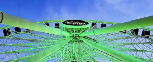 Centennial Wheel at Navy Pier in Chicago Navy Pier Centennial Wheel in Chicago, Illinois, viewed from below at blue hour with the Ferris wheel illuminated green and the Navy Pier logo visible at the center hub. Angled steel support legs, spokes and the circular wheel structure create a strong geometric view of the Dutch Wheels-designed attraction at Pier Park on the Chicago lakefront – © 2026 David Oppenheimer – Performance Impressions photography archives https://performanceimpressions.com Centennial Wheel, Navy Pier Centennial Wheel, Centennial Ferris Wheel, Centennial Wheel Chicago, Centennial Wheel Navy Pier, Navy Pier wheel, Navy Pier Ferris Wheel, Chicago Ferris wheel, Chicago wheel, Ferris wheel, observation wheel, giant wheel, wheel, Navy Pier, Navy Pier Chicago, Chicago Navy Pier, Pier Park, Navy Pier Pier Park, Ferris wheel ride, amusement ride, attraction, Chicago attraction, tourist attraction, Chicago landmark, lakefront attraction, Navy Pier logo, Navy Pier sign, center hub, wheel hub, digital hub, spokes, wheel spokes, gondolas, enclosed gondolas, passenger gondolas, support legs, wheel supports, steel supports, steel legs, steel beams, steel structure, structural steel, wheel structure, engineering, structural engineering, geometry, geometric, radial geometry, radial lines, circular, circle, symmetry, green, green lights, green lighting, green illumination, illuminated, illumination, lighting, blue hour, twilight, evening, low angle, looking up, upward view, dramatic perspective, architectural perspective, Streeterville, Streeterville Chicago, Near North Side, Chicago lakefront, Chicago waterfront, lakefront, waterfront, Lake Michigan, Grand Avenue, 600 East Grand Avenue, 600 E Grand Ave, 60611, Chicago, Chicago Illinois, Illinois, United States, USA, Dutch Wheels, Dutch Wheels BV, Netherlands, Navy Pier Inc, amusement, recreation, tourism, Chicago tourism, Chicago travel, entertainment, family attraction, outdoor attraction, city lights, night photography, blue hour photography, Ferris wheel photography, Navy Pier photography, Chicago photography, architectural photography, structural photography, travel photography, editorial photography, fine art photography, Chicago art, Navy Pier art, Ferris wheel art, photographic print, architectural print, fine art print, archival print, gallery print, collector print, wall art, licensing, image licensing, commercial imagery, photography licensing, art, print, fine art, commercial photography, David Oppenheimer, Performance Impressions, Performance Impressions photography archives, horizontal, 1-15213827141