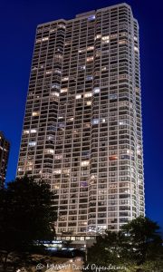 River Plaza Condominiums in Chicago at Twilight River Plaza Condominiums at 405 North Wabash Avenue rises above River North against a purple post-sunset sky, with illuminated windows forming a geometric pattern across its glass-and-concrete facade. Designed by Gordon & Levin and later converted from rental apartments to condominiums, the residential tower stands near the Chicago River in Chicago, Illinois – © 2026 David Oppenheimer – Performance Impressions photography archives https://performanceimpressions.com River Plaza Condominiums, River Plaza, River Plaza Chicago, River Plaza condos, River Plaza Tower, 405 North Wabash Avenue, 405 N Wabash Avenue, 405 N Wabash Ave, 405 North Wabash, North Wabash Avenue, Wabash Avenue, River North, River North Chicago, Near North Side, downtown Chicago, Chicago River, Chicago Riverwalk, Riverwalk, riverfront, Michigan Avenue, Magnificent Mile, Wrigley Building, Chicago, Chicago Illinois, Chicago IL, Illinois, 60611, facade, building exterior, exterior, tower exterior, glass facade, concrete facade, glass and concrete, window facade, window grid, illuminated facade, illuminated windows, building lights, window lights, facade lighting, geometric facade, facade pattern, window pattern, grid pattern, architectural pattern, reflections, purple sky, purple twilight, twilight, dusk, after sunset, evening, evening light, city lights, Chicago twilight, Chicago evening, condominium tower, condo tower, residential tower, residential high rise, residential skyscraper, condominium building, residential building, condominiums, condos, Chicago condos, River North condos, downtown condos, luxury condos, urban condos, high rise, skyscraper, tower, building, concrete tower, glass tower, housing, multifamily, former apartments, apartment conversion, condo conversion, real estate, River Plaza real estate, Chicago real estate, River North real estate, condominium real estate, condo real estate, residential real estate, downtown real estate, riverfront real estate, architecture, architectural photography, Chicago architecture, residential architecture, high-rise architecture, modern architecture, modernist architecture, postwar architecture, concrete architecture, structural engineering, high-strength concrete, reinforced concrete, Gordon & Levin, Gordon and Levin, Ezra Gordon, Jack M Levin, Margaret Young, McHugh Construction, James McHugh Construction, H S Nachman Associates, Field Enterprises, Community Specialists, Chicago skyline, urban architecture, city living, urban living, city views, river views, United States, licensing, image licensing, commercial imagery, photography licensing, art, print, fine art, commercial photography, David Oppenheimer, vertical, 1-15213827141