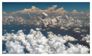 Towering Summer Clouds Aerial View Towering summer clouds aerial photo showing cumulus congestus clouds, developing cumulonimbus formations, and broad convective cloud fields rising above darker atmospheric haze and blue sky. Sunlit cloud tops, vertical cloud towers, and expanding storm structure emphasize summer weather, atmospheric instability, and high-altitude meteorology – © 2026 David Oppenheimer – Performance Impressions aerial photography archives https://performanceimpressions.com towering summer clouds, summer clouds aerial photo, towering clouds, clouds aerial view, aerial clouds, cloudscape, cloudscape aerial, cloud formations, cloud towers, cloud tops, towering cumulus, cumulus clouds, cumulus, cumulus congestus, developing cumulonimbus, cumulonimbus clouds, thunderstorm clouds, storm clouds, convective clouds, convection, atmospheric convection, weather, meteorology, atmosphere, atmospheric, sky, blue sky, white clouds, dramatic clouds, towering cloudscape, cloud texture, cloud structure, cloud field, cloud cover, cloud mass, atmospheric haze, weather pattern, weather system, storm development, thunderstorm development, unstable atmosphere, summer weather, moisture, humidity, vapor, water vapor, aerial, aerial photo, aerial photography, aerial photographer, aerial view, aerial image, high altitude, altitude, aviation, airplane view, flight, travel, nature, outdoors, environment, climate, climate imagery, scenic sky, sky photography, natural pattern, weather science, meteorological, United States, licensing, image licensing, commercial imagery, photography licensing, art, print, fine art, commercial photography, David Oppenheimer, horizontal, 1-15156784411