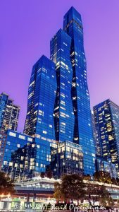 The St. Regis Chicago Glass Tower at Twilight The St. Regis Chicago at 401 East Upper Wacker Drive rises above Lakeshore East at twilight, its illuminated windows articulating three interconnected volumes of blue-green glass against a purple post-sunset sky. Viewed from the Chicago River, the 101-story luxury hotel and condominium tower designed by Jeanne Gang of Studio Gang forms a sculptural landmark near Lake Michigan in Chicago, Illinois – © 2026 David Oppenheimer – Performance Impressions photography archives https://performanceimpressions.com The St. Regis Chicago, St. Regis Chicago, The St. Regis Chicago Hotel, St. Regis Hotel Chicago, The Residences at The St. Regis Chicago, St. Regis Chicago Residences, St. Regis Hotels & Resorts, 401 East Upper Wacker Drive, 401 E Upper Wacker Drive, 401 E Upper Wacker Dr, 401 East Wacker Drive, 401 E Wacker Drive, 363 East Wacker Drive, 363 E Wacker Drive, Vista Tower, Vista Tower Chicago, Wanda Vista Tower, Lakeshore East, Lakeshore East Chicago, New Eastside, Chicago Loop, Loop Chicago, downtown Chicago, East Wacker Drive, Upper Wacker Drive, Wacker Drive, Chicago River, Chicago Riverwalk, Riverwalk, riverfront, Lake Michigan, Chicago lakefront, DuSable Harbor, Navy Pier, Millennium Park, Chicago, Chicago Illinois, Chicago IL, Illinois, 60601, facade, building exterior, exterior, tower exterior, upper tower, glass facade, glass tower, glass towers, glass skyscraper, glass curtain wall, curtain wall, blue-green glass, gradient glass, aqua glass, reflective glass, high-performance glass, faceted facade, sculptural facade, geometric facade, three-volume tower, interconnected volumes, three towers, stacked frustums, frustum geometry, truncated pyramids, stepped edges, tapered tower, illuminated facade, illuminated windows, building lights, window lights, facade lighting, city lights, reflections, twilight, Chicago twilight, purple twilight, purple sky, post-sunset sky, dusk, after sunset, evening, skyline lights, luxury hotel, five-star hotel, Chicago hotel, Chicago luxury hotel, downtown hotel, riverfront hotel, Lake Michigan hotel, Marriott hotel, hotel tower, hotel, hospitality, luxury hospitality, St. Regis Butler Service, Marriott International, Marriott Bonvoy, Marriott stock, NASDAQ MAR, MAR stock, mixed-use tower, mixed-use building, condominium tower, residential tower, condominiums, luxury condos, luxury residences, Chicago condos, Lakeshore East condos, skyscraper, supertall, high rise, tower, building, 101-story tower, Chicago skyline, Chicago cityscape, skyline, cityscape, urban, city views, river views, lake views, real estate, Chicago real estate, Lakeshore East real estate, hotel real estate, hospitality real estate, condominium real estate, residential real estate, luxury real estate, riverfront real estate, commercial real estate, contemporary architecture, modern architecture, sculptural architecture, geometric architecture, high-rise architecture, riverfront architecture, Chicago architecture, architectural photography, architecture, engineering, structural engineering, wind engineering, reinforced concrete, blow-through floor, tuned liquid dampers, Studio Gang, Jeanne Gang, bKL Architecture, bKL Architects, Gensler, HBA, Magnusson Klemencic Associates, MKA, McHugh Construction, Power Construction, OLIN, Magellan Development Group, Gencom, GD Holdings, Gencom GD Holdings, hotel ownership, hotel investment, boat view, river view, Chicago River cruise, architecture cruise, urban photography, twilight photography, hotel photography, United States, licensing, image licensing, commercial imagery, photography licensing, art, print, fine art, commercial photography, David Oppenheimer, vertical, 1-15213827141