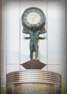 Tiffany & Co. Atlas Clock on Chicago’s Magnificent Mile Tiffany & Co. Atlas Clock above the entrance at 730 North Michigan Avenue in Chicago anchors a tightly framed view of the Magnificent Mile storefront, with the Atlas figure holding a Roman-numeral clock above the revolving doors. Tiffany & Co. signage, warm metallic tones, curved entrance details, and strong vertical facade lines give the photograph a surreal, highly rendered fine-art character in Chicago, Illinois – © 2026 David Oppenheimer – Performance Impressions photography archives https://performanceimpressions.com