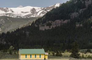 Abandoned Yellow Schoolhouse in Rocky Mountains